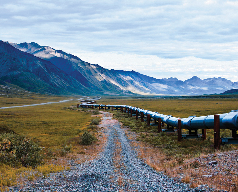 Abdoned pipeline in the field with mountains